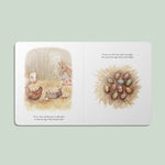 Illustrated book page with farm animals and painted eggs on a light green background