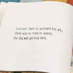 Open book with a quote about the ark on a wooden surface