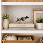 Decorative shelf with books, a figurine, and plants