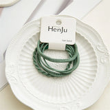 Green hair bands on a white plate with HenJu label