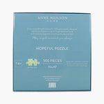 Box of Anne Neilson Home Hopeful Puzzle with puzzle piece illustration
