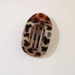 Tortoiseshell patterned hair clip on a white background