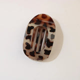Tortoiseshell patterned hair clip on a white background