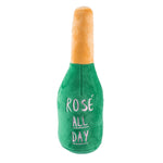 plush dog toy shaped like a champagne bottle saying "rose all day"