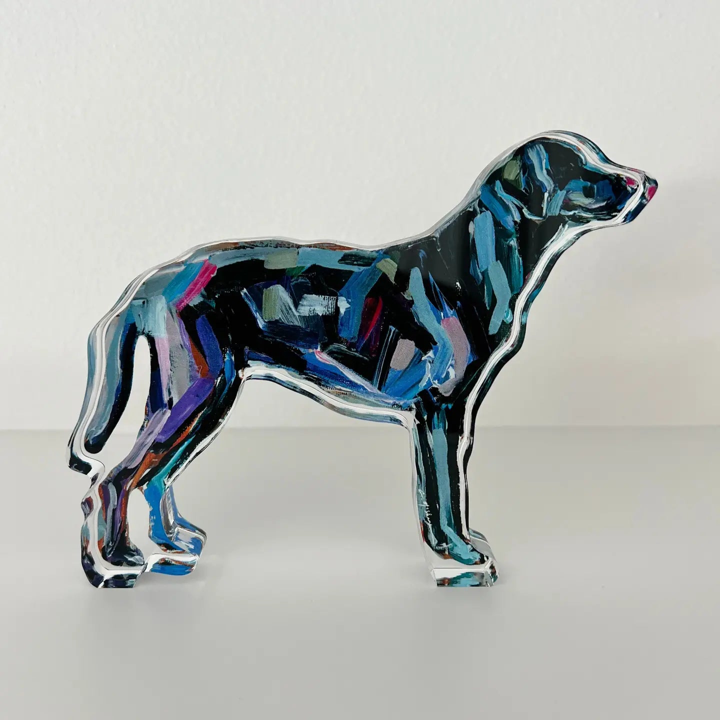 Colorful glass dog sculpture on a white background