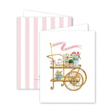Greeting card with a gold cart and flowers on a white background