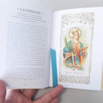 Open book with a illustration of Saint Catherine and text on a white background