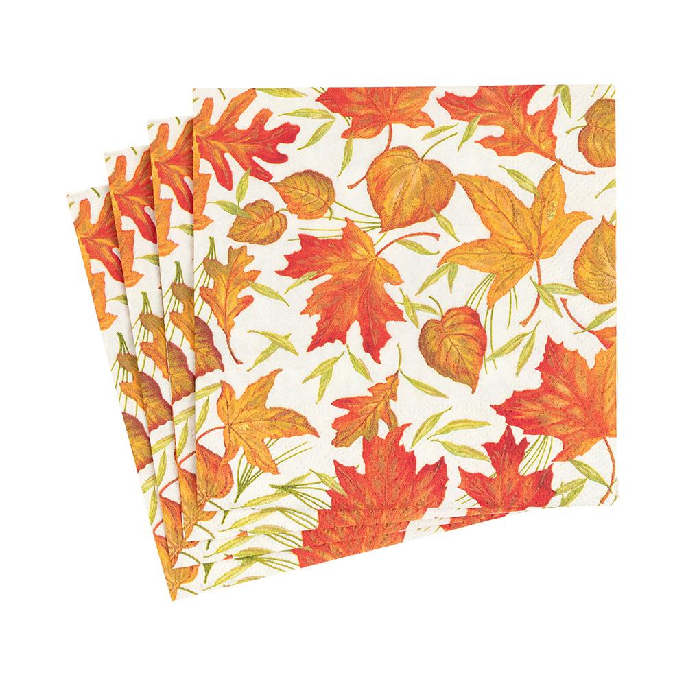 A stack of square paper napkins featuring a colorful autumn leaf pattern with red, orange, and yellow maple leaves on a white background.