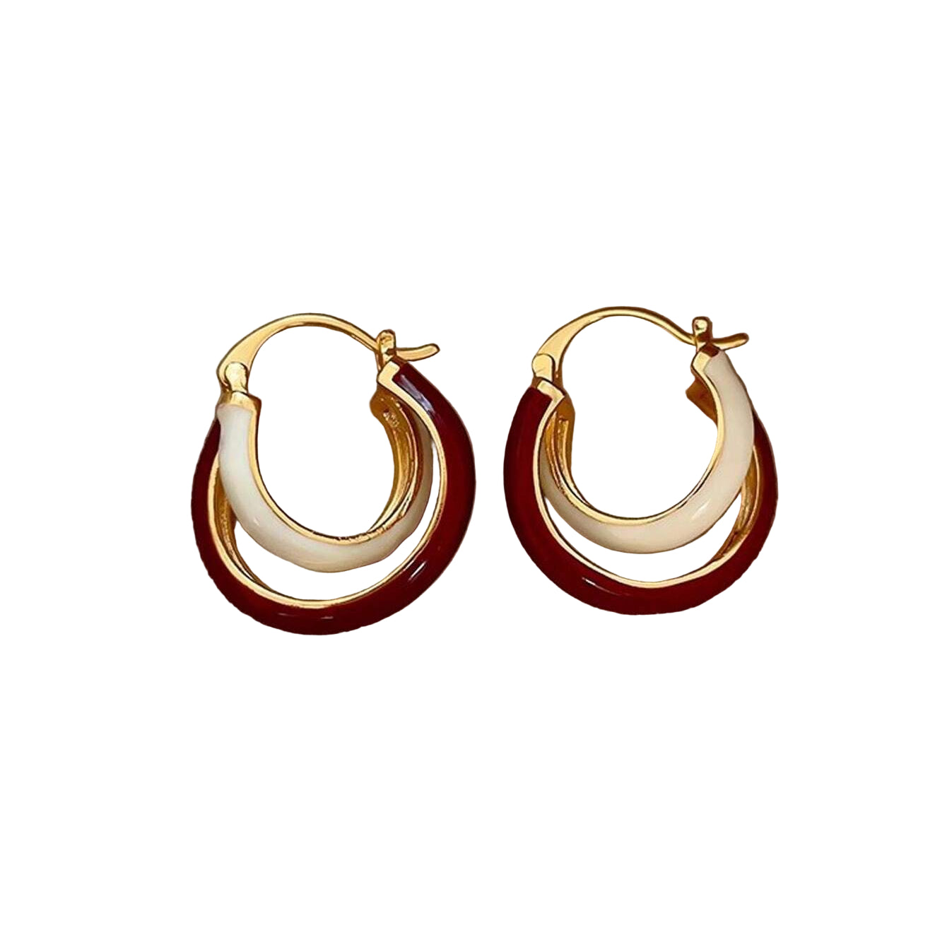 Pair of gold hoop earrings with red and white accents on a beige fabric background