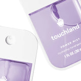 Purple hand sanitizer bottle with 'touchland' branding on a white background