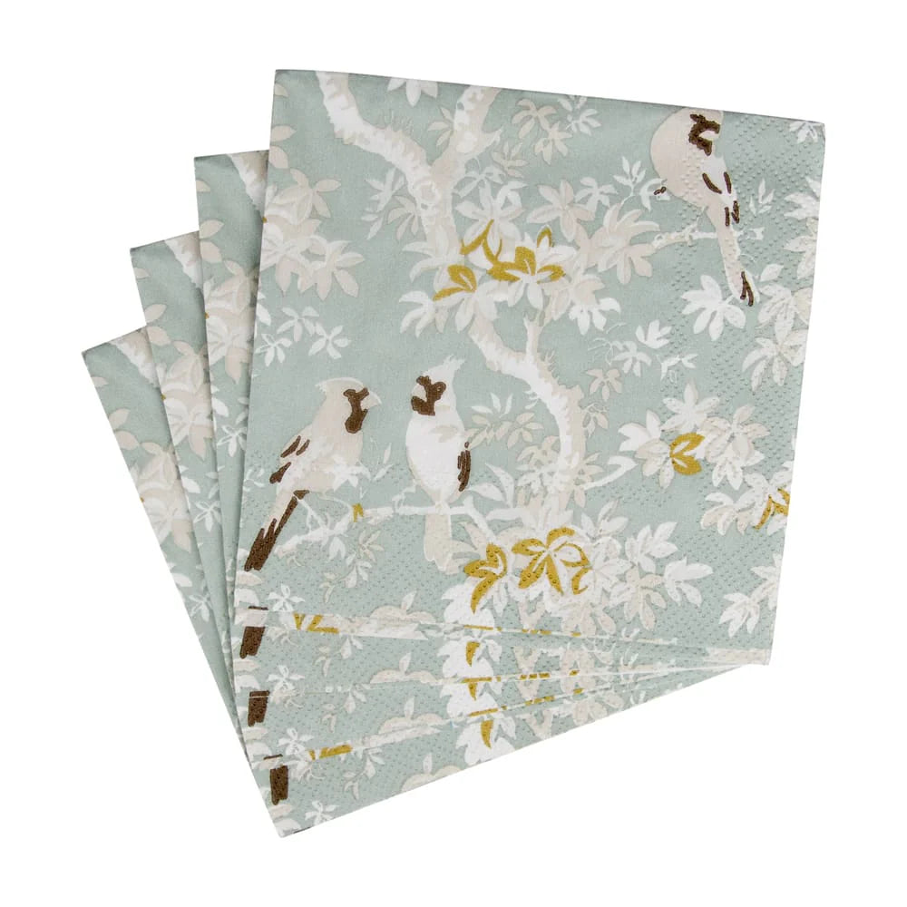 Set of folded paper napkins with bird and floral pattern on a light blue background