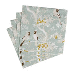 Set of folded paper napkins with bird and floral pattern on a light blue background