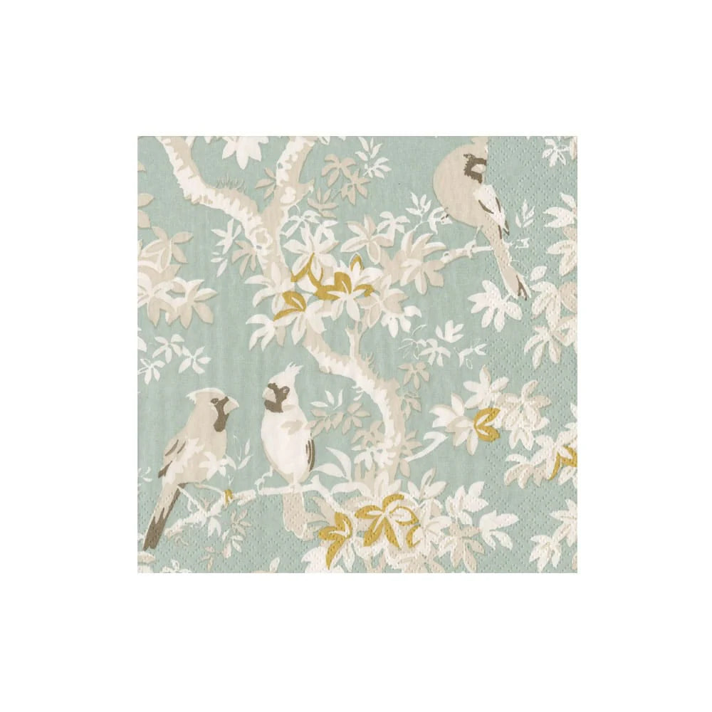Patterned paper cocktail napkins with birds and floral design on a light blue background