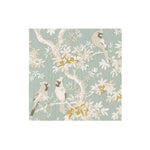 Patterned paper cocktail napkins with birds and floral design on a light blue background
