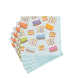Set of colorful cocktail napkins with cake and candle designs on a white background