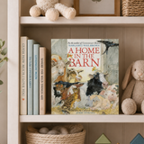 Children's book titled 'A Home in the Barn' on a shelf with toys and books.