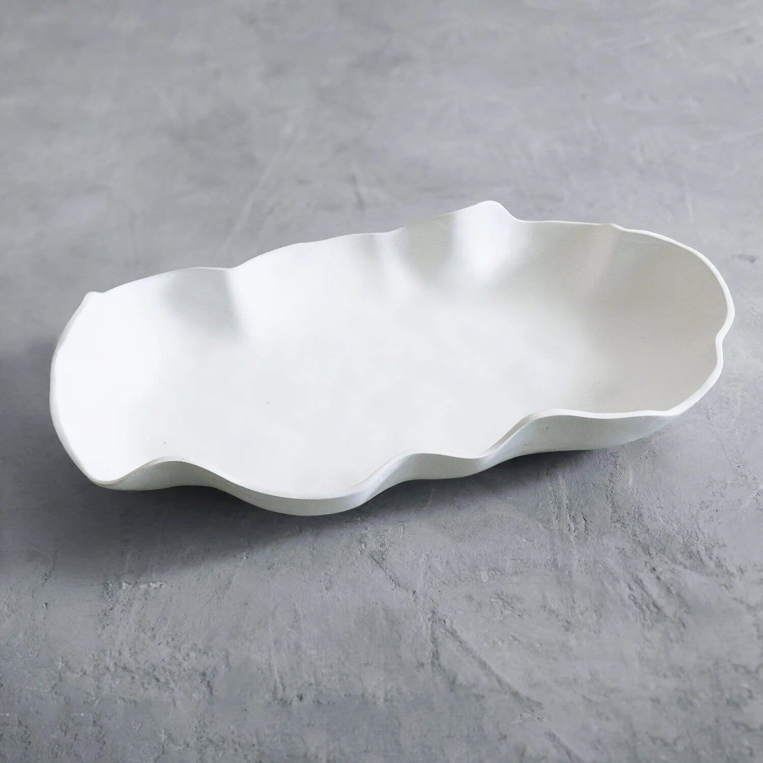 beatriz ball vida nube large platter on gray concrete surface