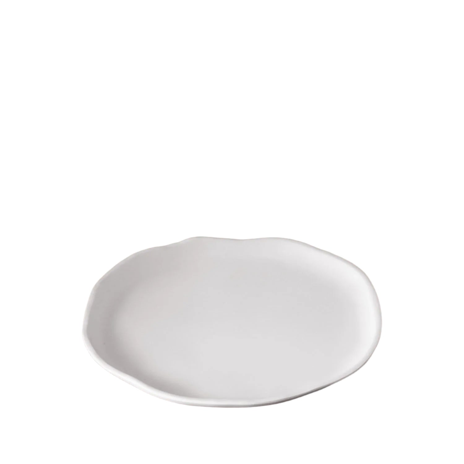 White ceramic plate on a wooden table with a blurred background