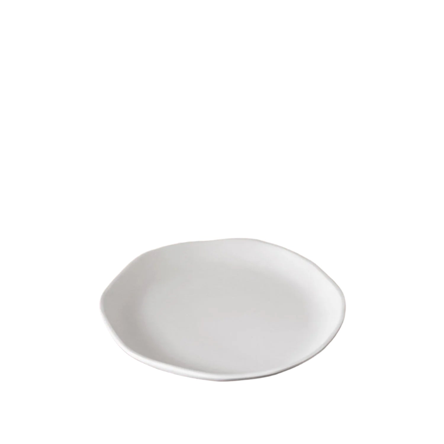 White plate on a wooden table with a blurred background