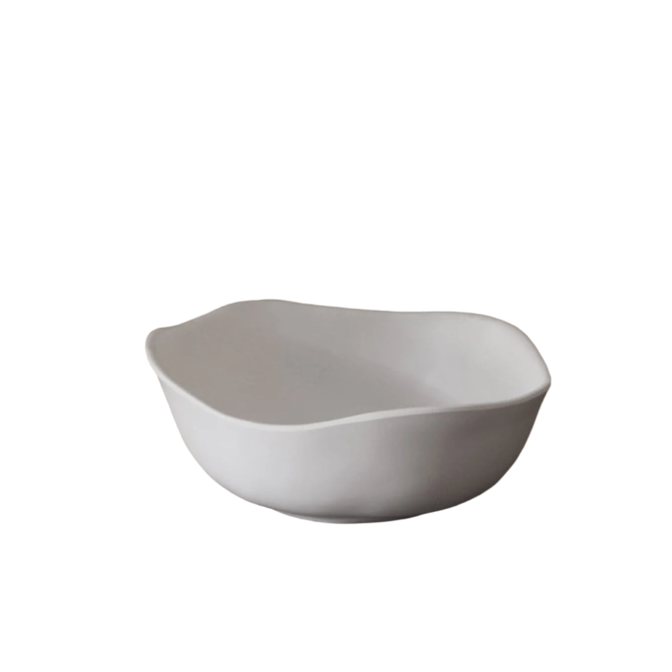 White ceramic bowl on a wooden table with a blurred background