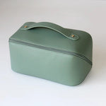 Green travel case with a handle on a white background