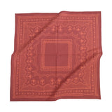 Red bandana with intricate patterns on a white background
