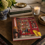 Book titled 'English Country House Style' on a table with decor items.