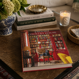 Book titled 'English Country House Style' on a table with decor items.