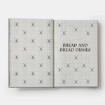 Open book with a patterned cover titled 'Bread and Bread Dishes' on a white background