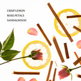 Spices and herbs with lemon slices, rose petals, and sandalwood on a white background.