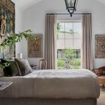Cozy bedroom with a bed, wardrobe, and decorative elements.