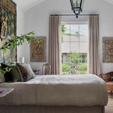 Cozy bedroom with a bed, wardrobe, and decorative elements.