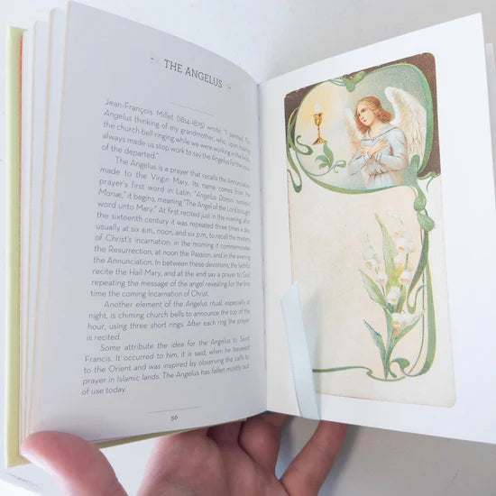 Open book with an angel illustration on a white background