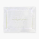 White pillowcase with embroidered green text 'May Angels Surround You Always' on a white background