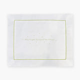 White pillowcase with embroidered green text 'May Angels Surround You Always' on a white background