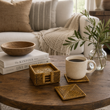 Cozy living room with a wooden table featuring a cup of coffee, books, a bowl, and a plant.