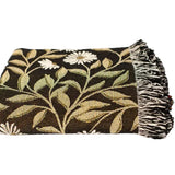 Floral patterned throw blanket with fringes on a white background