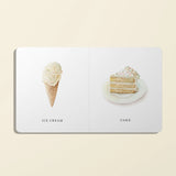 Book with illustrations of ice cream and cake on a beige background