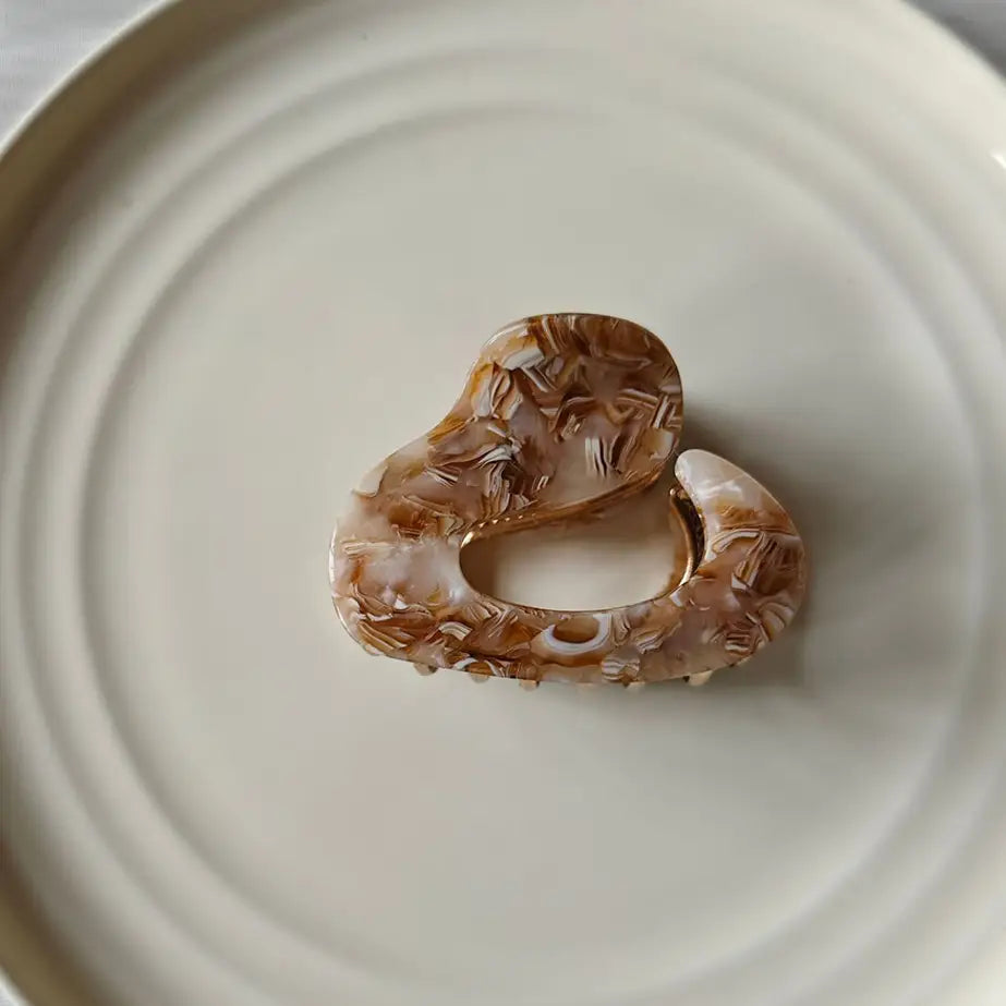 marblized hair claw on white ceramic plate