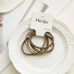 Brown hair bands on a white plate with HenJu label
