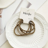 Brown hair bands on a white plate with HenJu label
