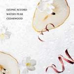 Sliced pear with flowers and ribbons on a textured white background, labeled 'Ozonic Accord Watery Pear Cedarwood'.