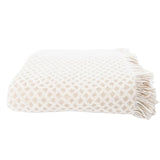 Textured blanket with fringe on a white background