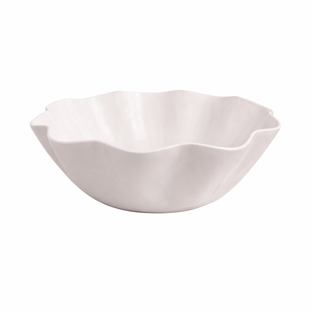 White enamel bowl with a wavy edge on a white background