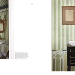 Bathroom interior with striped wallpaper, sink, and decorative elements.