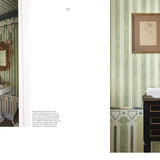 Bathroom interior with striped wallpaper, sink, and decorative elements.