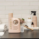 LAVANT laundry detergent bottle on a counter with other products against a tiled wall background