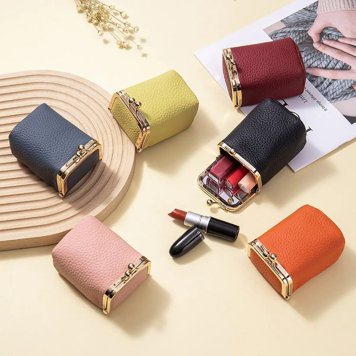 Colorful lipstick cases with a black lipstick on a light surface.