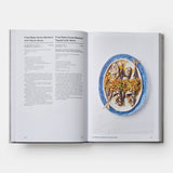 Open cookbook showing a plate of food with a recipe on a white background