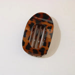 Tortoiseshell patterned hair clip on a white background